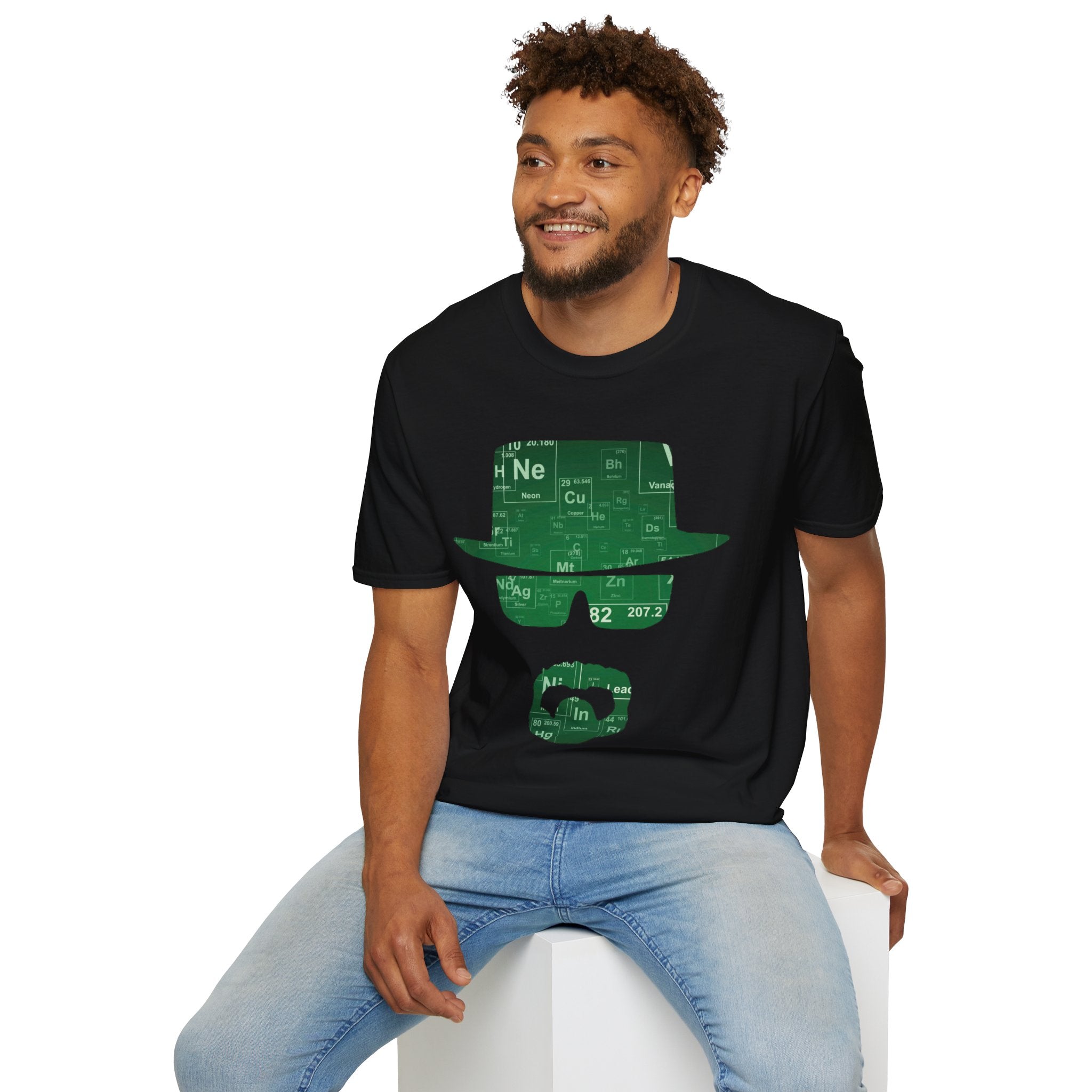 Man wearing a black t-shirt with a green graphic design on a white background